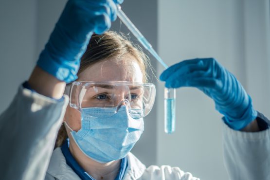 Female,Scientist,Wearing,Safety,Equipment,Carefully,Transfers,Liquid,With,Pipette